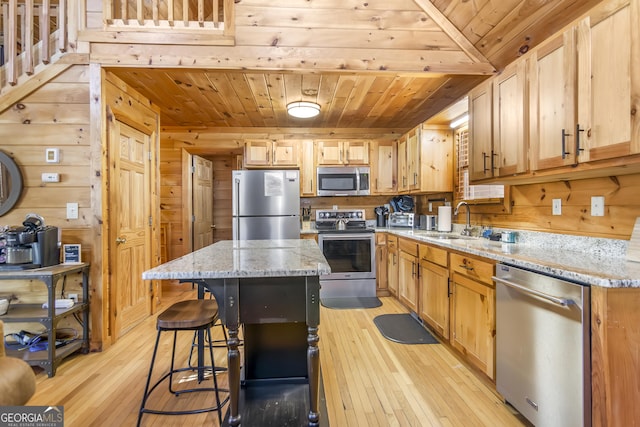 211 Highland Forest Dr, Morganton, GA 30560 - kitchen with stainless steel appliances, a center island, wood walls, wood ceiling, and light wood finished floors