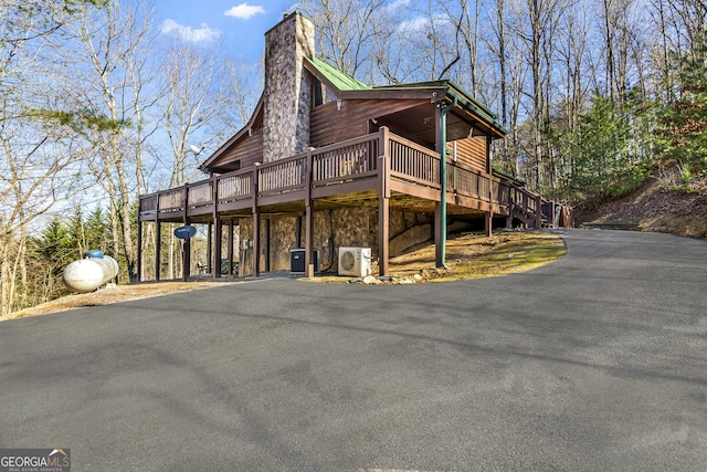 211 Highland Forest Dr, Morganton, GA 30560 - exterior space featuring ac unit, log veneer siding, a deck, a chimney, and driveway