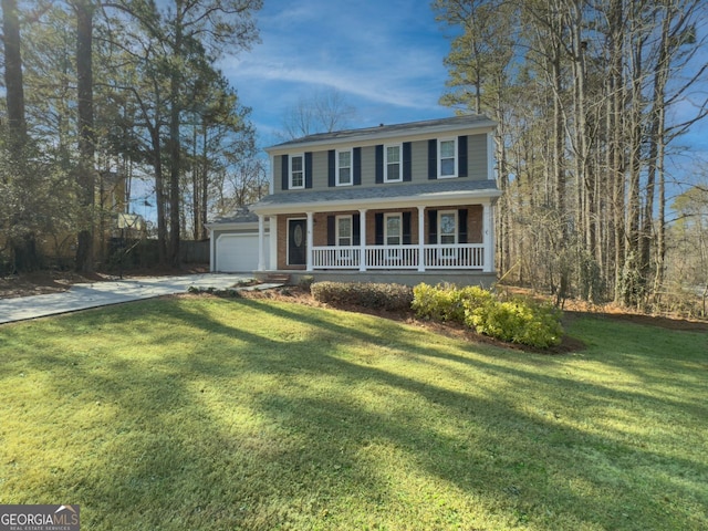 view of front of home with a garage, a front lawn, and covered porch