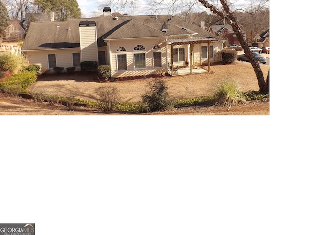 view of front of home featuring a pergola and a patio