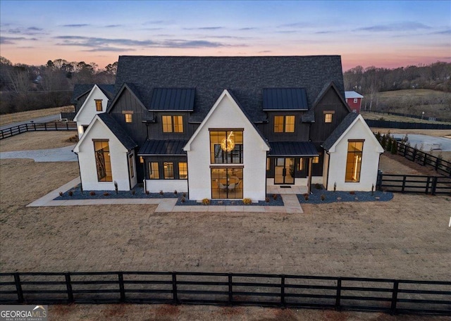 view of back house at dusk