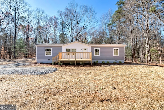 manufactured / mobile home with a front yard and a deck