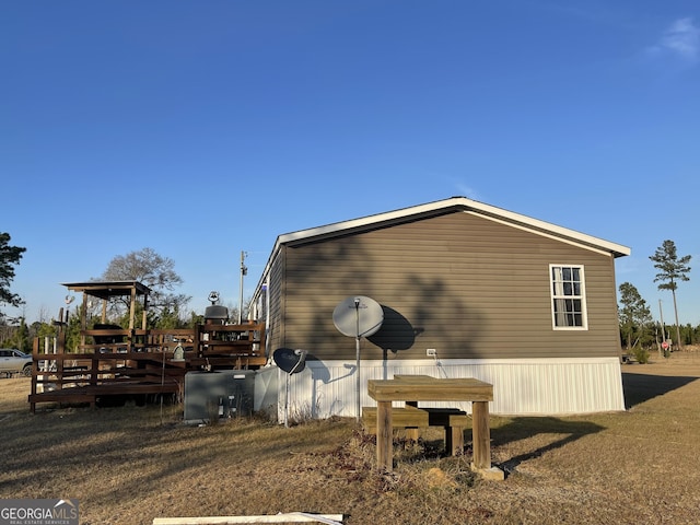 view of side of home with a wooden deck