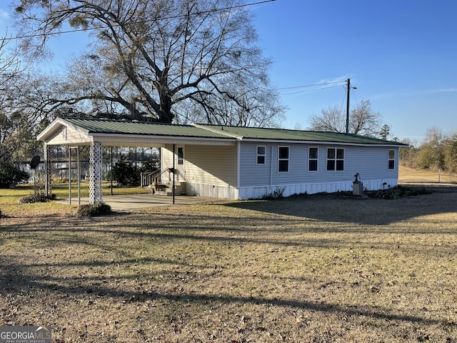 exterior space with a carport and a front yard