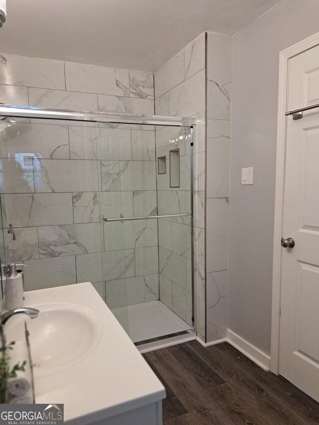 1290 Elizabeth Ave SW, Atlanta, GA 30310 - bathroom with wood finished floors, a stall shower, vanity, and baseboards