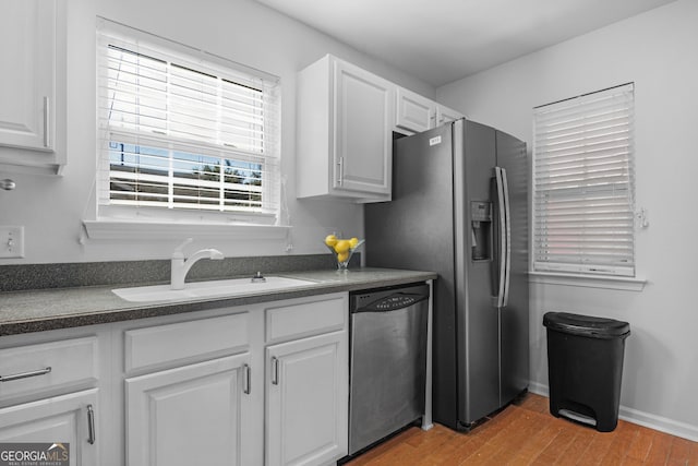 172 Sonata Cir, Pooler, GA 31322 - kitchen featuring appliances with stainless steel finishes, dark countertops, white cabinets, and wood finished floors
