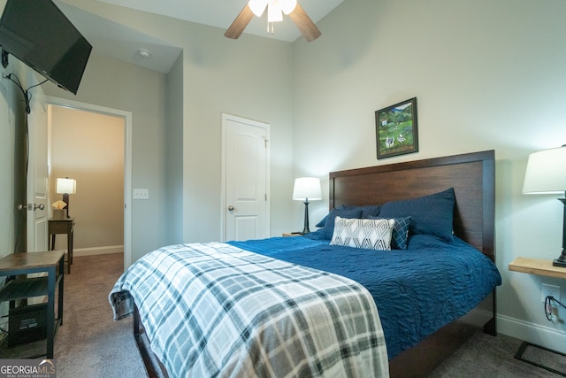 bedroom with ceiling fan, lofted ceiling, and carpet