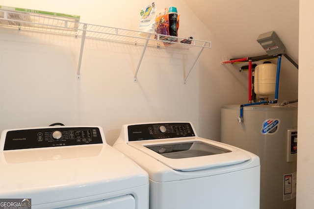 washroom with water heater and independent washer and dryer