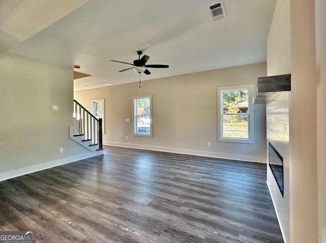 unfurnished living room with ceiling fan and dark hardwood / wood-style floors