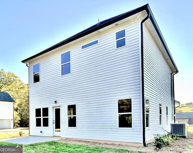 rear view of house with a patio and central air condition unit