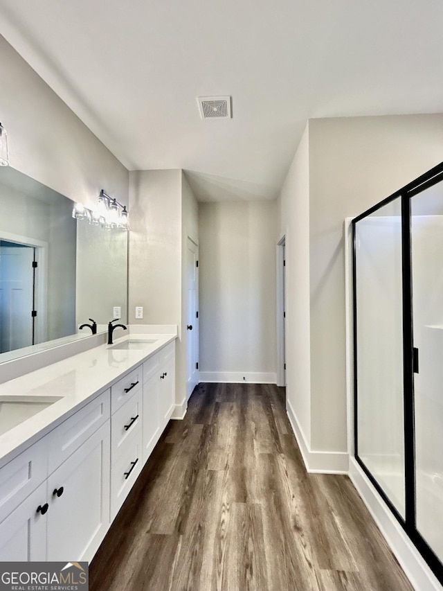 bathroom featuring hardwood / wood-style flooring and vanity