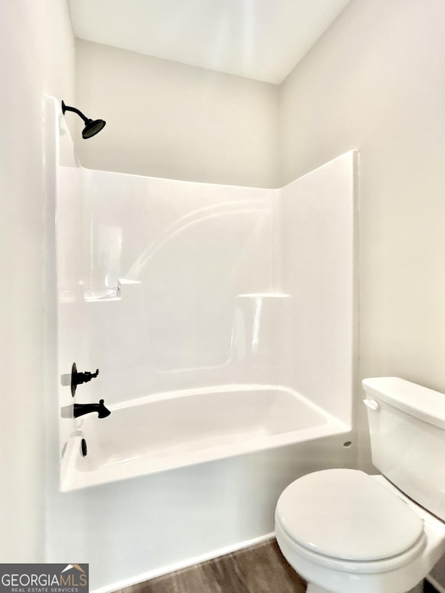 bathroom featuring wood-type flooring, toilet, and shower / bath combination