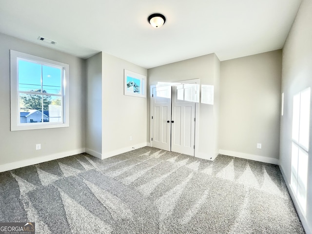 unfurnished bedroom featuring carpet flooring and a closet