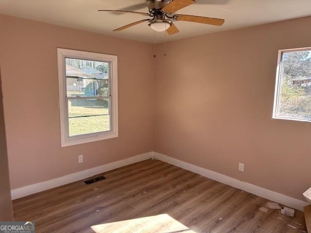 spare room with wood-type flooring and ceiling fan