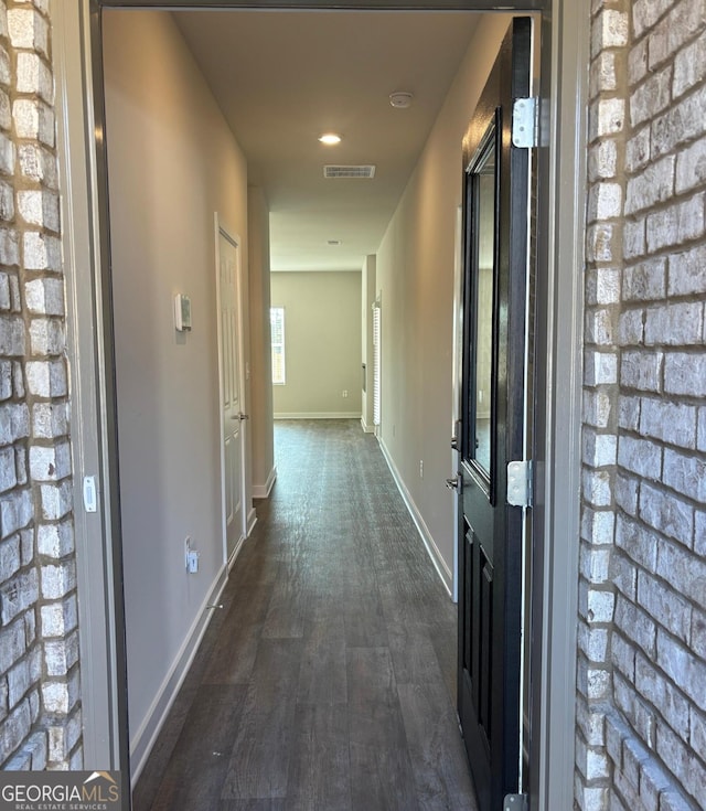 corridor featuring dark wood-type flooring