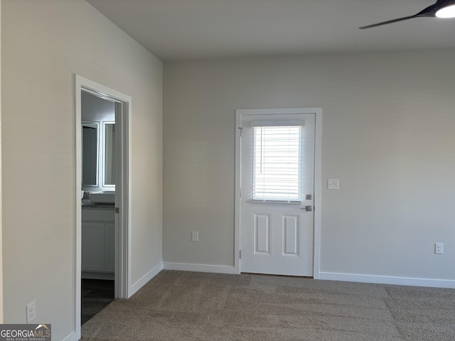 interior space with carpet flooring and ceiling fan