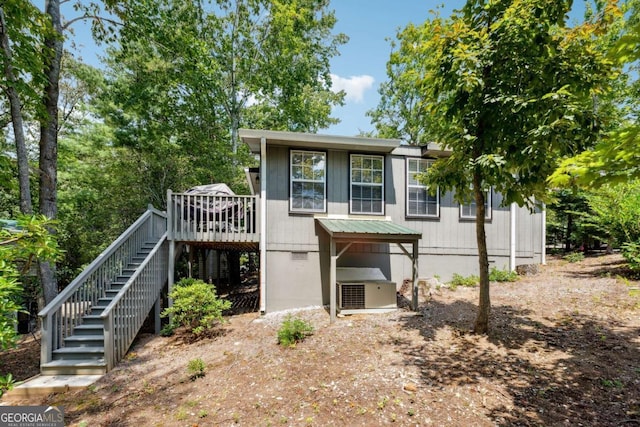 rear view of property featuring a deck