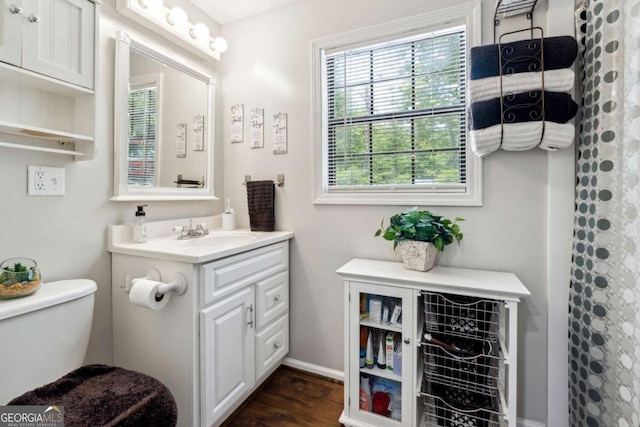 bathroom featuring hardwood / wood-style flooring, vanity, toilet, and a shower with curtain