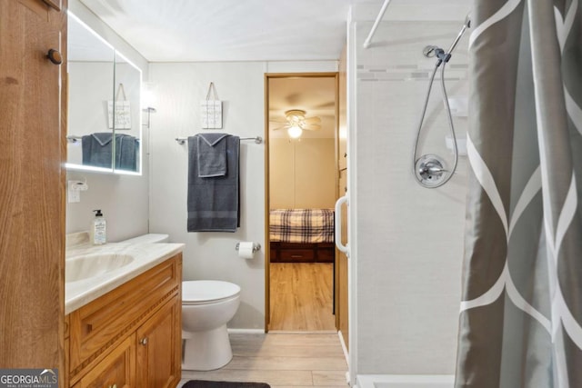 bathroom with vanity, hardwood / wood-style flooring, toilet, and a shower with shower curtain