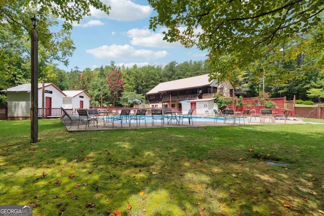 view of yard featuring a storage shed and a patio