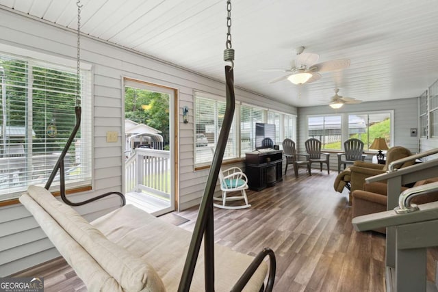 sunroom / solarium featuring ceiling fan and a healthy amount of sunlight