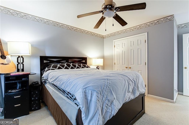 bedroom featuring light carpet, ceiling fan, and a closet