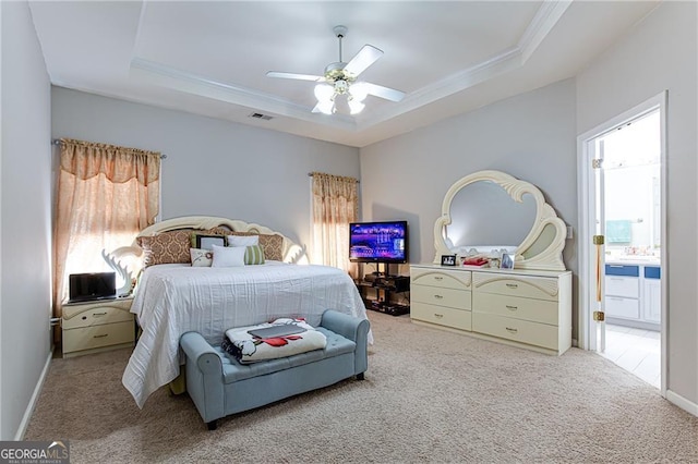 carpeted bedroom with a raised ceiling, ornamental molding, and ceiling fan