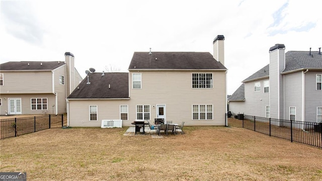 back of house featuring a lawn