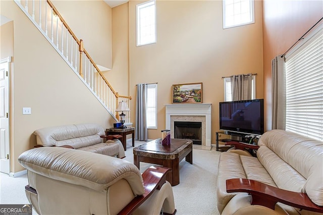 living room featuring light carpet and a towering ceiling