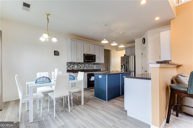 kitchen featuring pendant lighting, gray cabinetry, a chandelier, decorative backsplash, and stainless steel refrigerator with ice dispenser