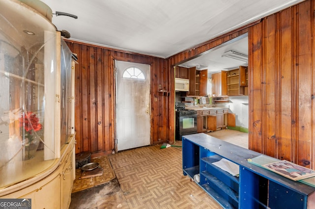 foyer entrance with light parquet flooring and wood walls