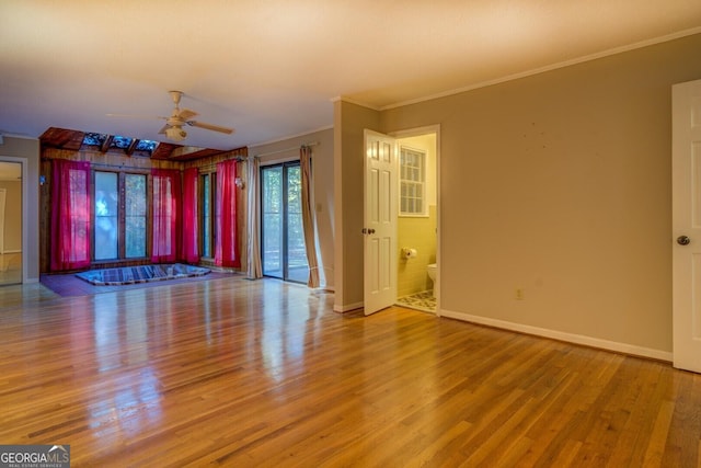 unfurnished living room featuring crown molding, ceiling fan, and hardwood / wood-style flooring