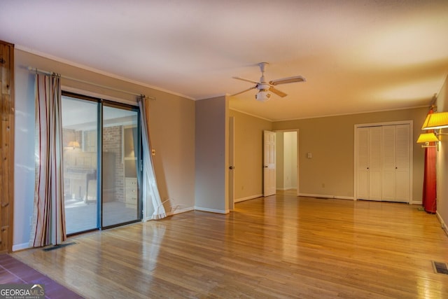 empty room featuring crown molding, ceiling fan, and light hardwood / wood-style floors