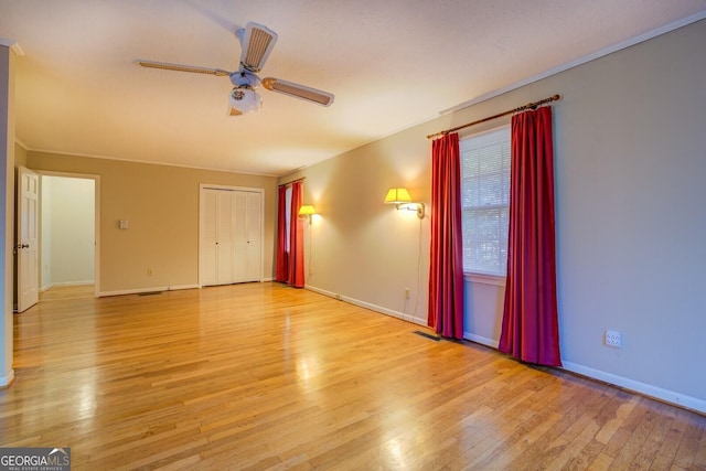 unfurnished room with ceiling fan and light hardwood / wood-style floors