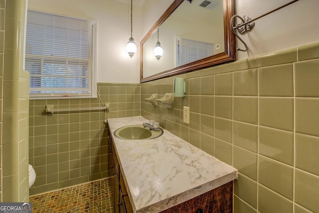 bathroom featuring tile walls and vanity