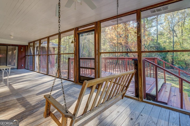 unfurnished sunroom with a healthy amount of sunlight and ceiling fan