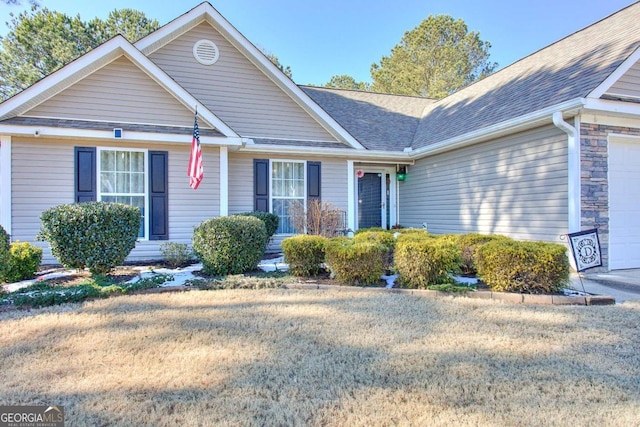 view of front of home with a garage and a front lawn