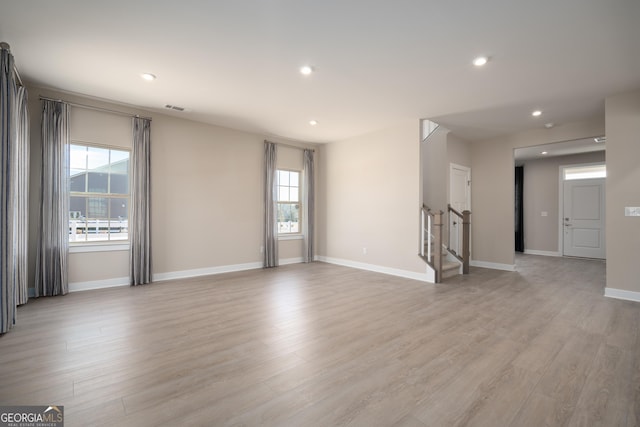 empty room featuring light hardwood / wood-style floors and a healthy amount of sunlight