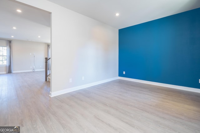 spare room with light hardwood / wood-style flooring