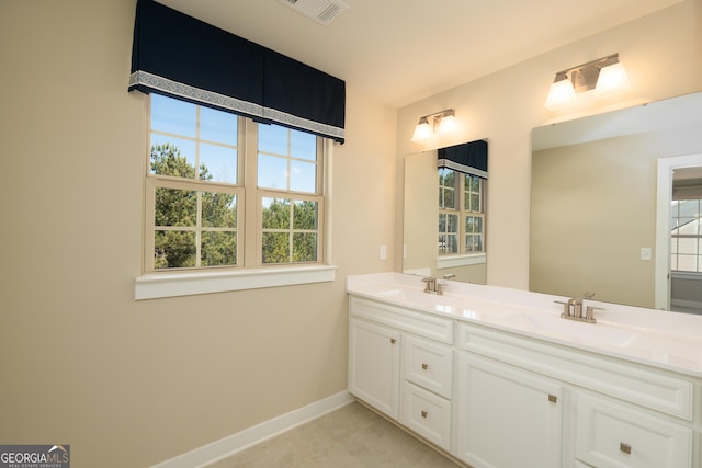 bathroom featuring tile patterned flooring and vanity