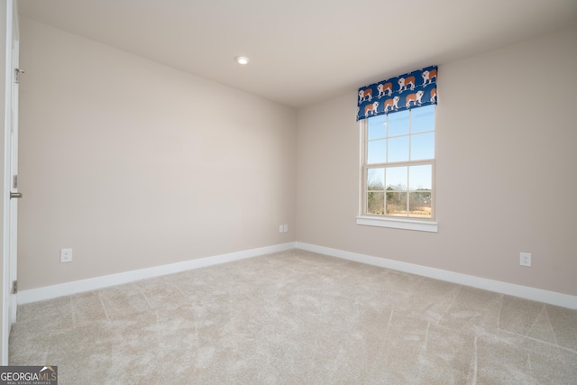 empty room featuring light carpet