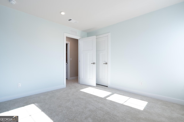 unfurnished bedroom with light colored carpet