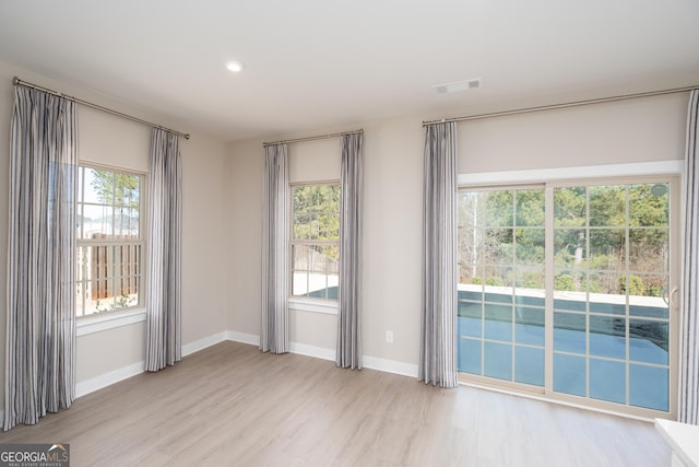 empty room with light hardwood / wood-style flooring