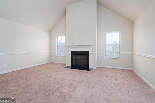 unfurnished living room with light carpet and vaulted ceiling