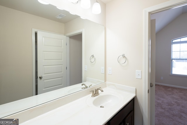 bathroom featuring vanity and vaulted ceiling