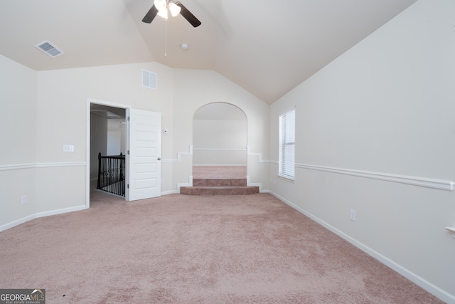 carpeted spare room with vaulted ceiling and ceiling fan