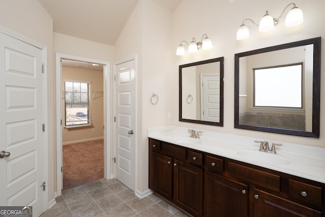 bathroom with lofted ceiling and vanity