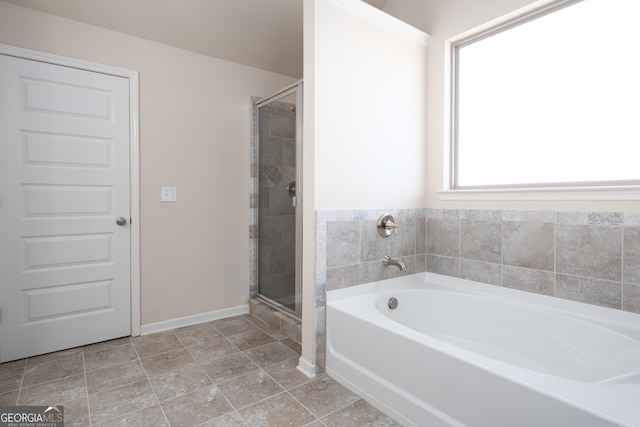 bathroom featuring independent shower and bath and a healthy amount of sunlight