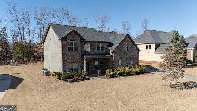 view of front facade featuring central AC unit and a garage