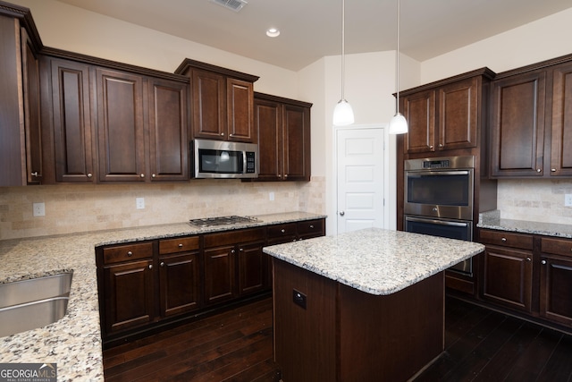 kitchen featuring pendant lighting, appliances with stainless steel finishes, and backsplash